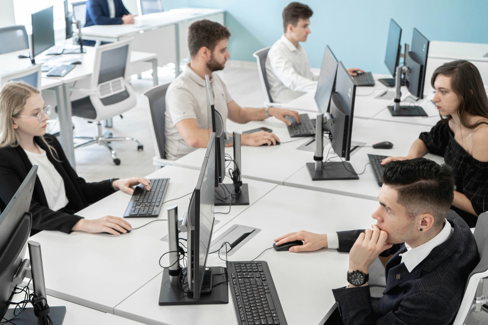 Équipe IT travaillant sur des postes informatiques